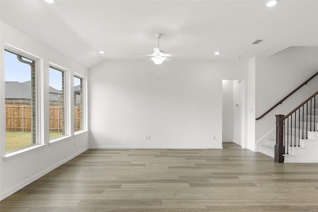 spare room with vaulted ceiling, ceiling fan, and light hardwood / wood-style flooring