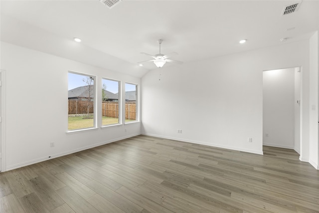 unfurnished room featuring lofted ceiling, wood-type flooring, and ceiling fan