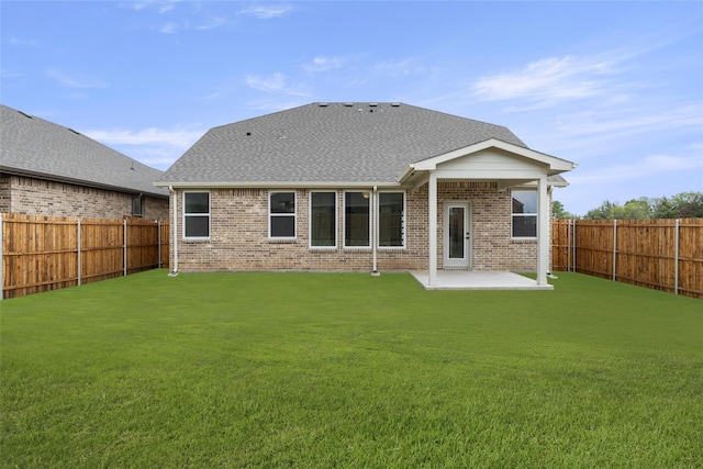 back of house featuring a yard and a patio area