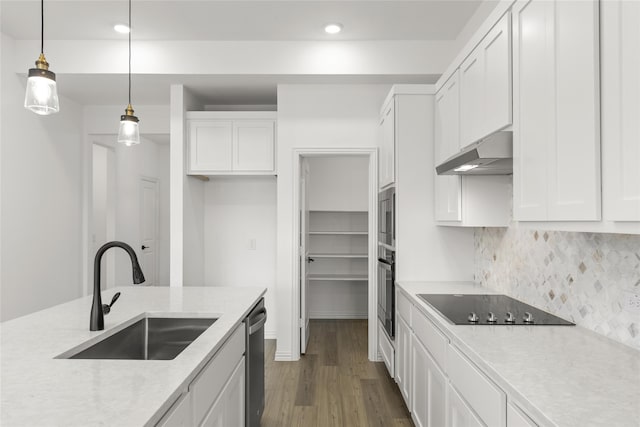 kitchen featuring white cabinetry, sink, hanging light fixtures, and black appliances