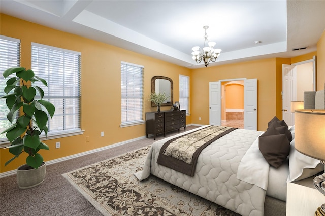 bedroom with carpet flooring, a tray ceiling, and a notable chandelier