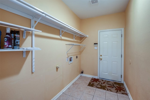 clothes washing area with washer hookup, light tile patterned floors, and electric dryer hookup