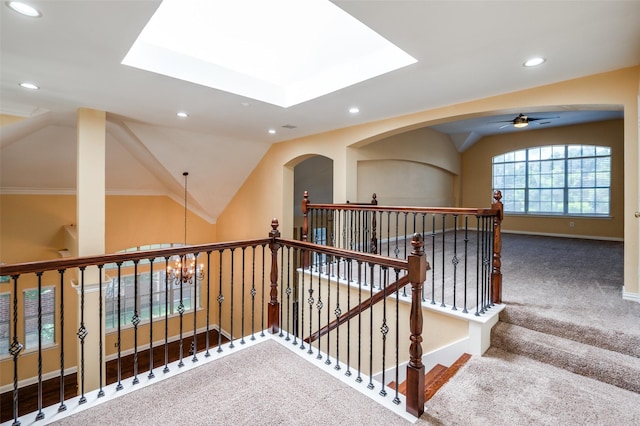 stairs featuring carpet, ceiling fan, crown molding, and vaulted ceiling