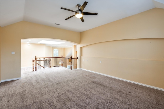 spare room featuring ceiling fan, carpet floors, and lofted ceiling