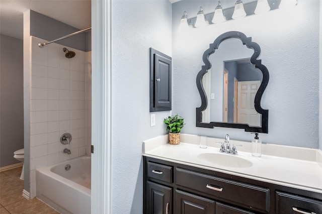 full bathroom with tile patterned flooring, vanity, toilet, and tiled shower / bath