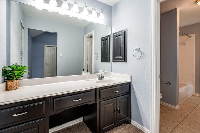 full bathroom featuring tile patterned floors, toilet, vanity, and tiled shower / bath