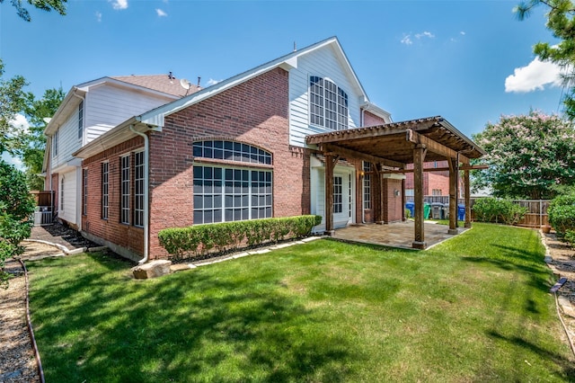 rear view of house with central AC unit, a patio area, and a lawn