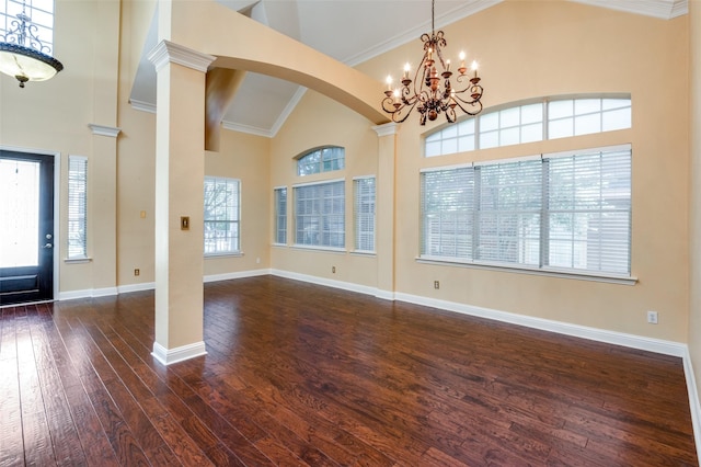 entrance foyer featuring crown molding, high vaulted ceiling, a chandelier, and dark hardwood / wood-style floors