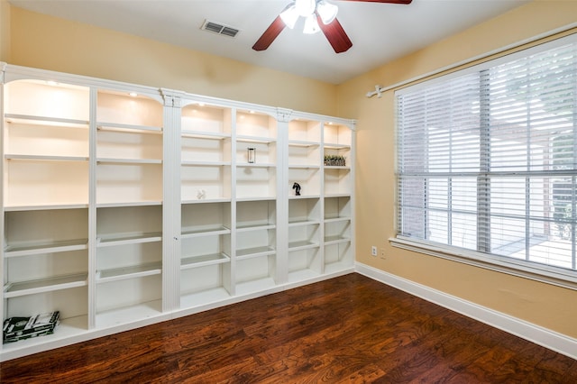 spare room with dark hardwood / wood-style flooring and ceiling fan