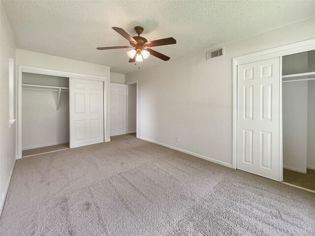 unfurnished bedroom with light carpet, ceiling fan, visible vents, and baseboards