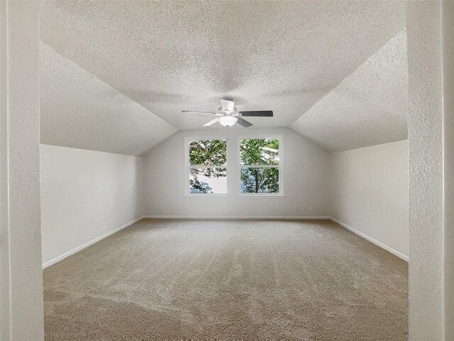 additional living space featuring carpet floors, ceiling fan, and lofted ceiling