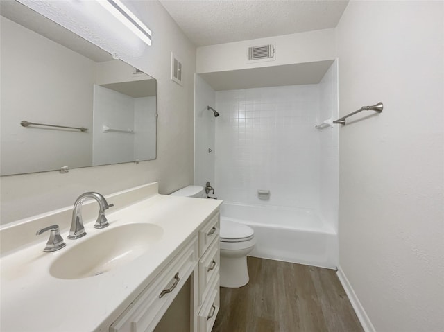 full bath featuring visible vents, vanity, toilet, and wood finished floors