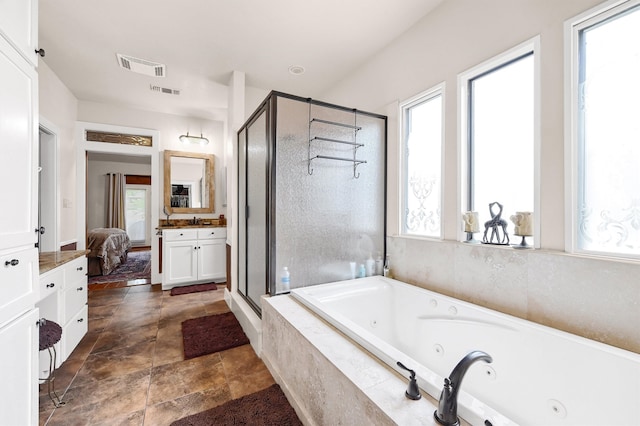 bathroom with vanity, tile patterned flooring, a wealth of natural light, and separate shower and tub