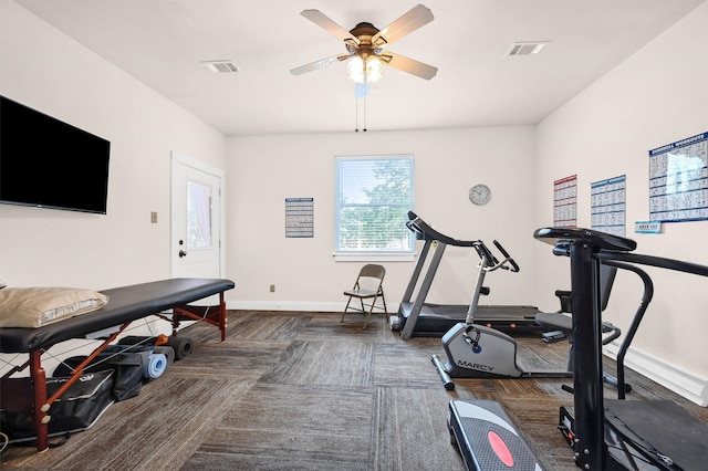 exercise room with dark hardwood / wood-style floors and ceiling fan