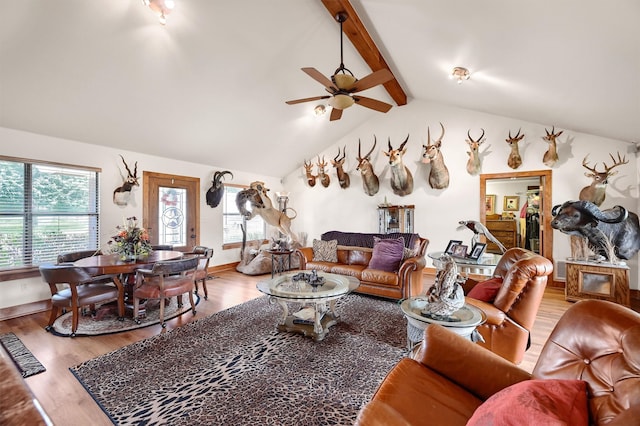 living room with wood-type flooring, vaulted ceiling with beams, and ceiling fan