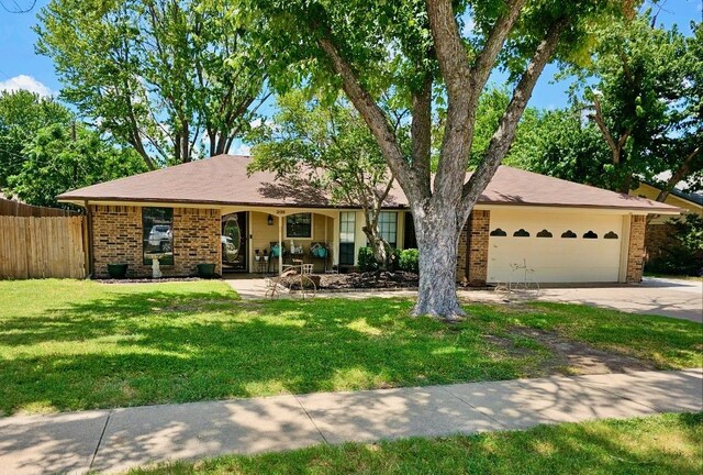 ranch-style home featuring a garage and a front yard