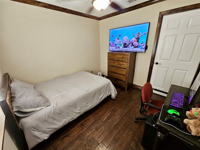 bedroom with ornamental molding and dark hardwood / wood-style floors