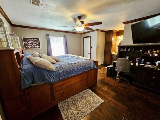 bedroom with ceiling fan, ornamental molding, dark hardwood / wood-style floors, and a textured ceiling