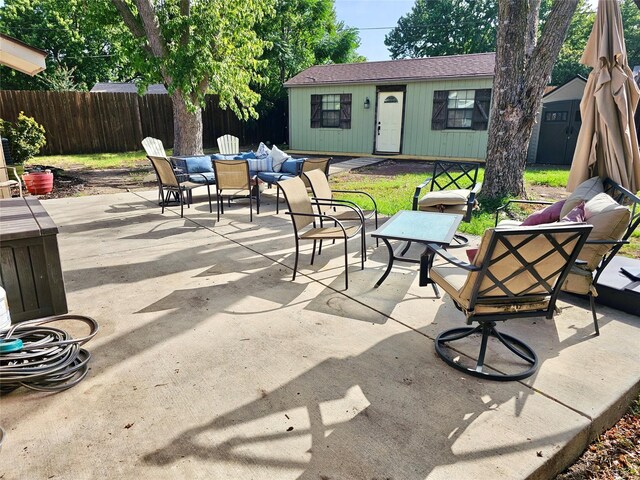 view of patio featuring an outbuilding and outdoor lounge area