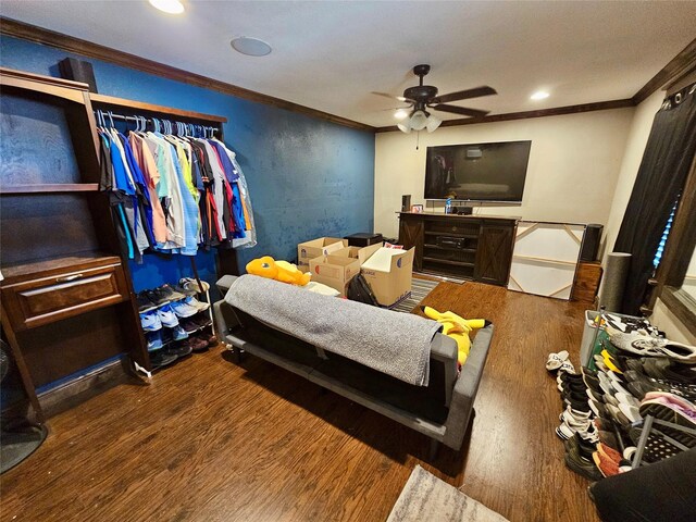 bedroom with dark wood-type flooring, ceiling fan, and crown molding