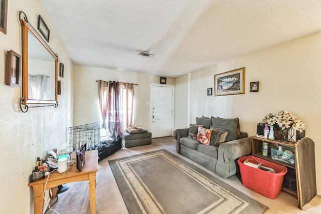 carpeted living room featuring visible vents and a textured ceiling