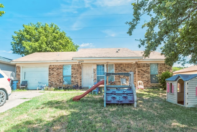 ranch-style home featuring a garage, an outbuilding, and a front lawn