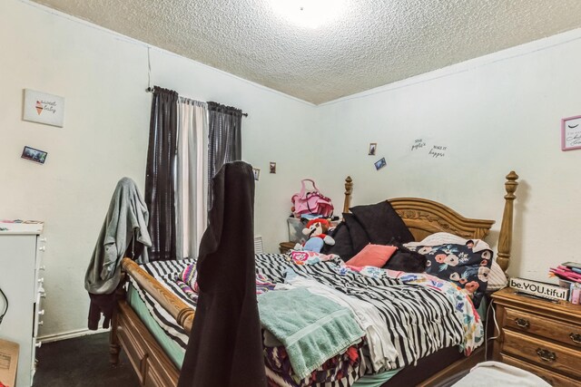 carpeted bedroom featuring a textured ceiling