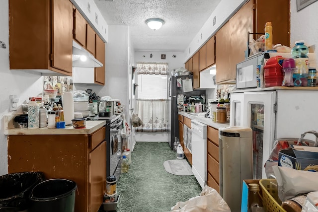 kitchen with dishwasher, range, and a textured ceiling