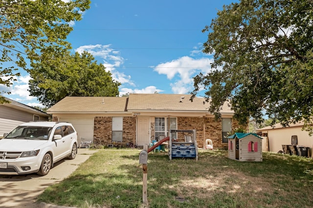 ranch-style house with a storage shed, a garage, and a front lawn