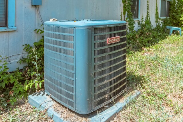 exterior details with wood walls and central air condition unit