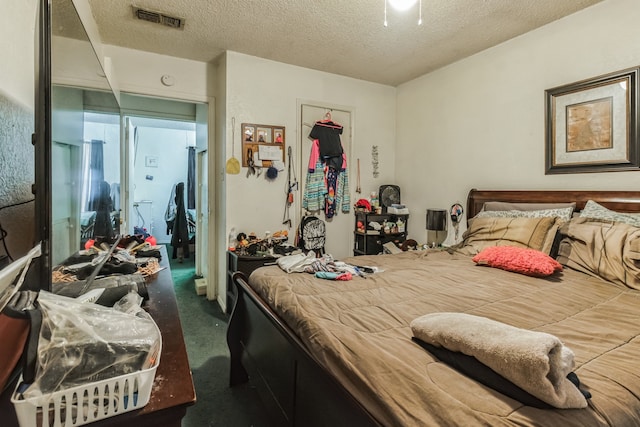 carpeted bedroom with a closet and a textured ceiling