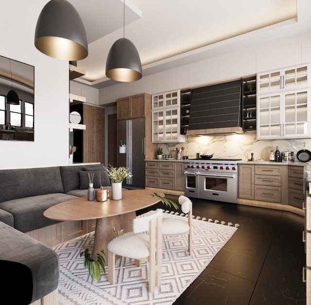 kitchen featuring ventilation hood, a tray ceiling, stainless steel appliances, decorative backsplash, and a kitchen breakfast bar