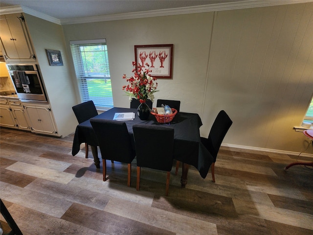 dining area featuring ornamental molding and light hardwood / wood-style flooring