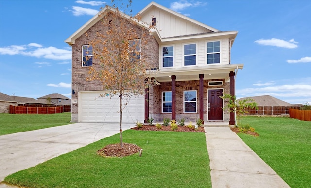 view of front of property with brick siding, board and batten siding, a front yard, fence, and a garage