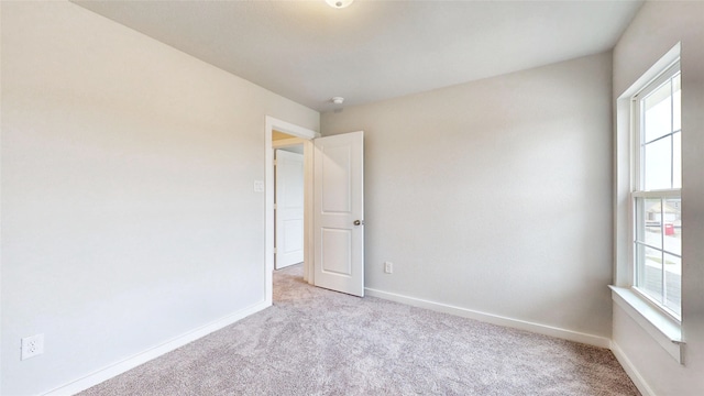 empty room featuring light colored carpet