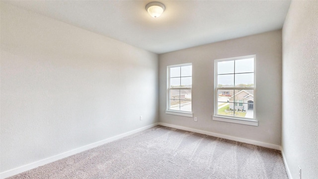 spare room with carpet floors and baseboards