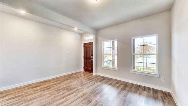 entryway with baseboards and wood finished floors