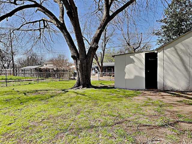 view of yard featuring fence and an outdoor structure