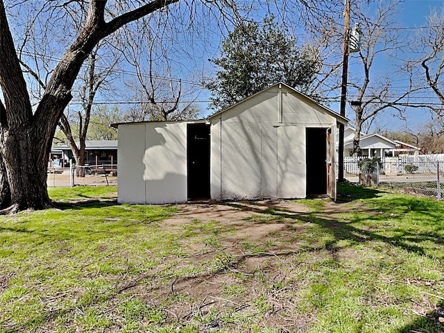 view of shed featuring fence