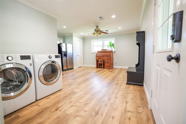 laundry area featuring ceiling fan, washer and dryer, crown molding, and light hardwood / wood-style floors