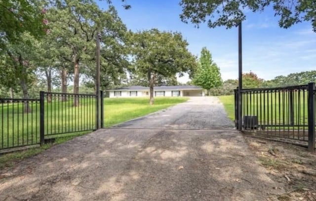 view of gate featuring a yard