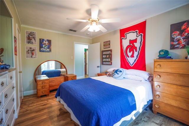 bedroom with ceiling fan, dark hardwood / wood-style flooring, and ornamental molding