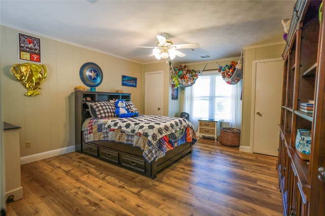 bedroom featuring ceiling fan, dark hardwood / wood-style flooring, and crown molding