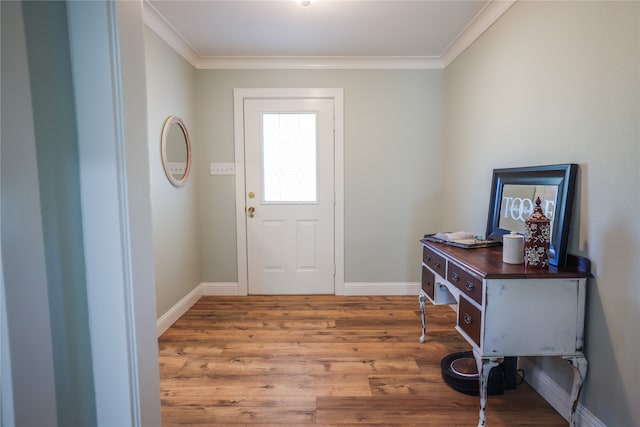 entrance foyer featuring crown molding and hardwood / wood-style flooring