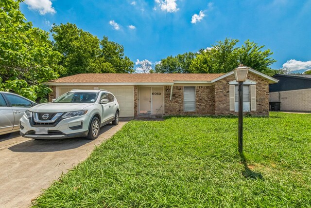 single story home with a garage and a front yard