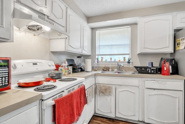 kitchen featuring white cabinetry, white range with electric stovetop, dark hardwood / wood-style flooring, and sink