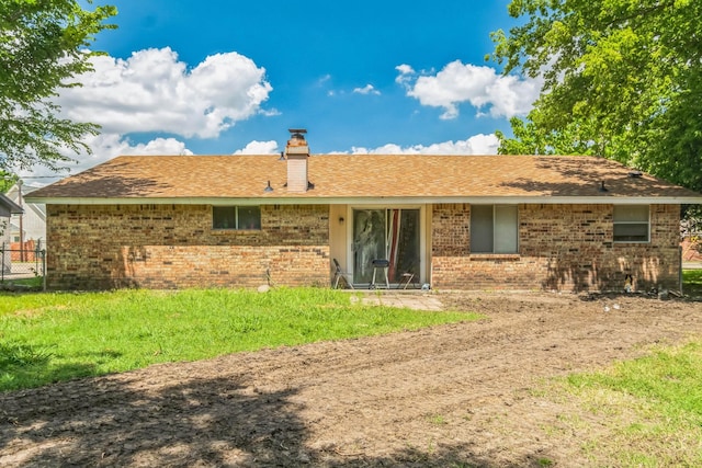 rear view of property with brick siding and a chimney