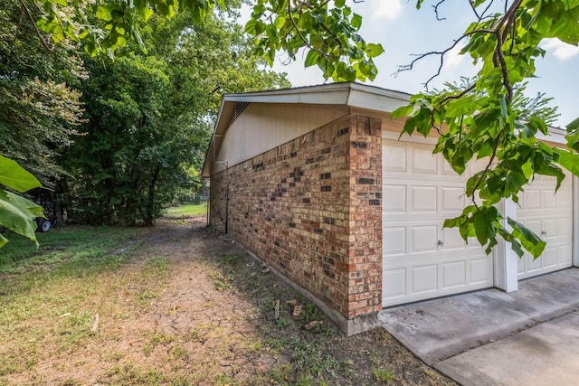 garage featuring concrete driveway