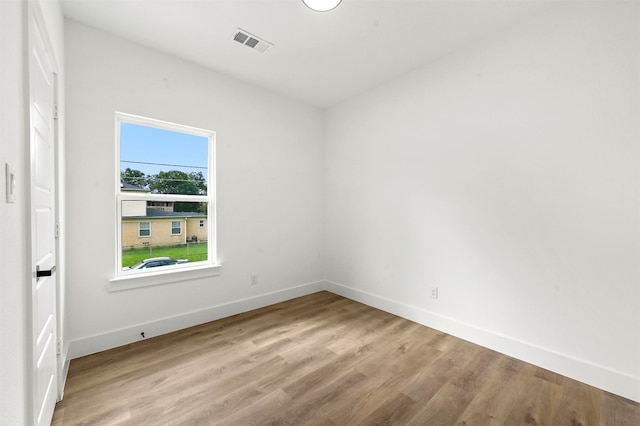 spare room with hardwood / wood-style flooring