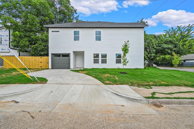 view of front of house with a garage and a front lawn